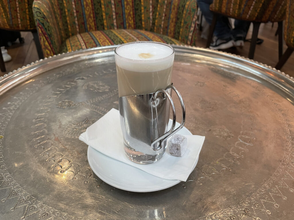 a glass of coffee on a plate