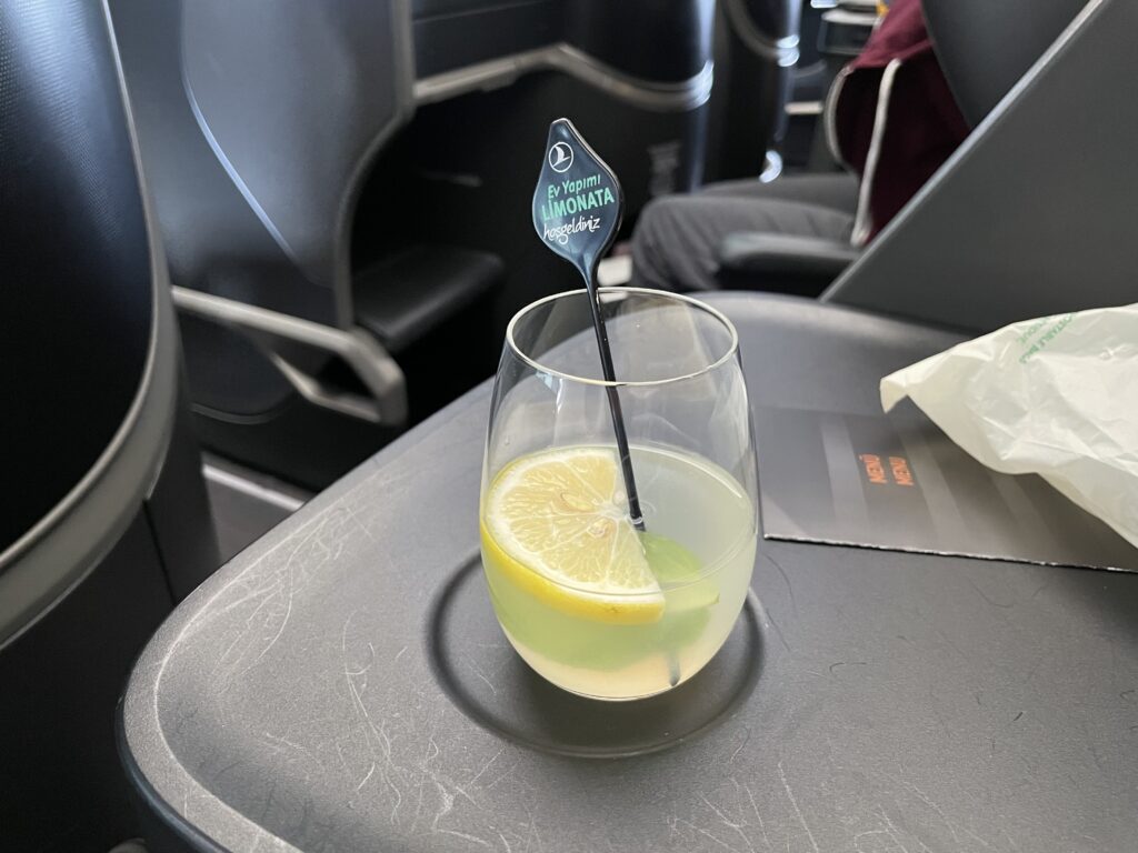 a glass with a lemon and a straw in it
