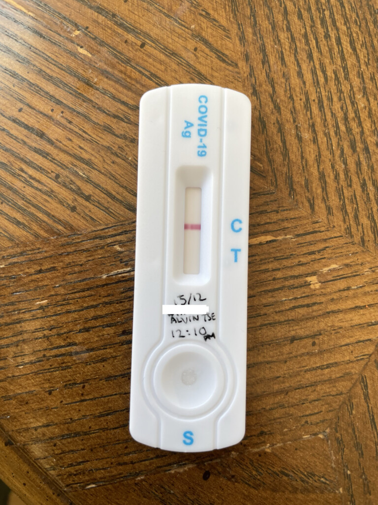 a white test strip with blue text on it