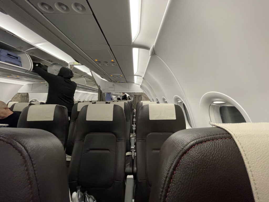 a person cleaning the seats of an airplane