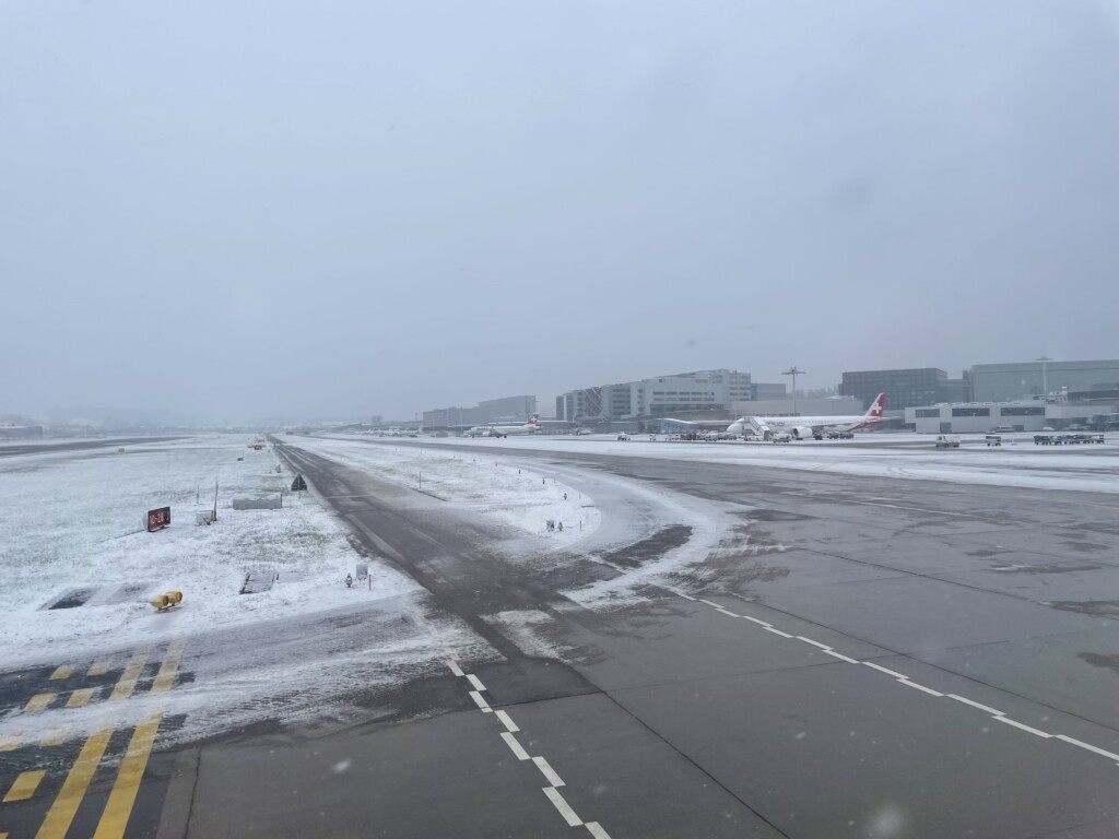 an airport runway with snow on it