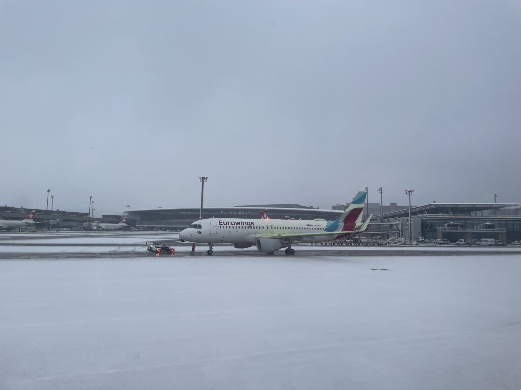 an airplane on a runway in the snow
