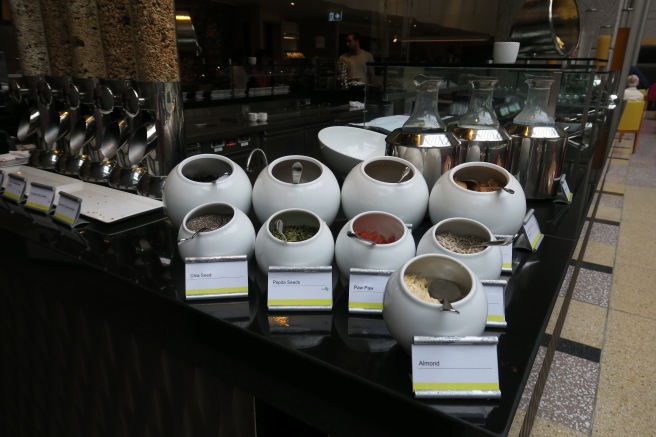 a group of white containers with different spices