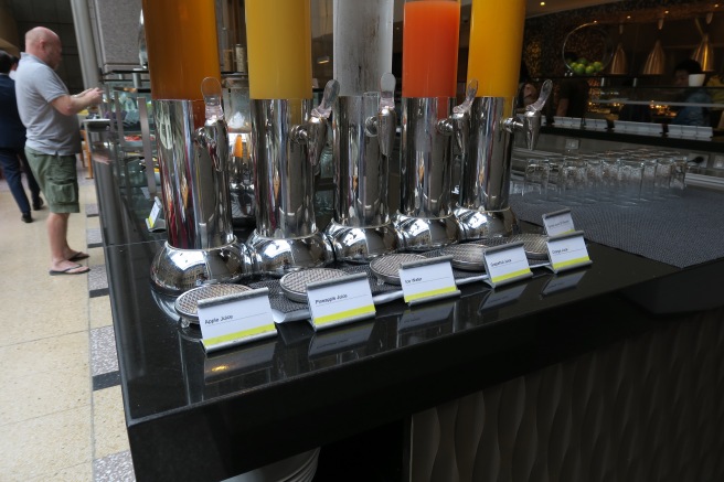 a group of juice dispensers on a table