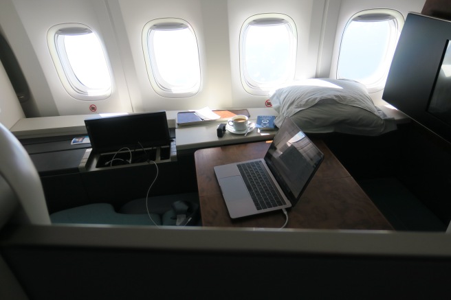 a laptop on a desk in an airplane