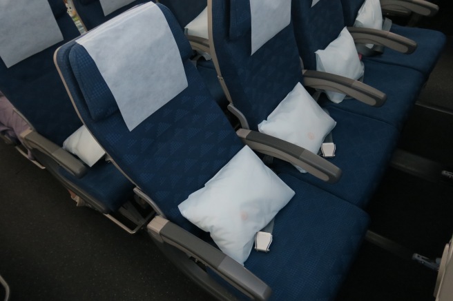 a row of seats with white pillows