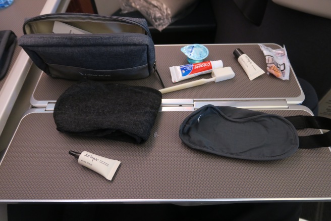 a table with a bag and a toiletries and a mask