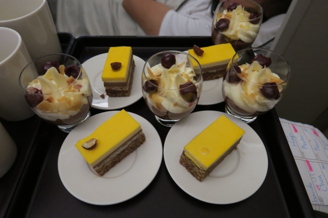 a tray of desserts on a black surface