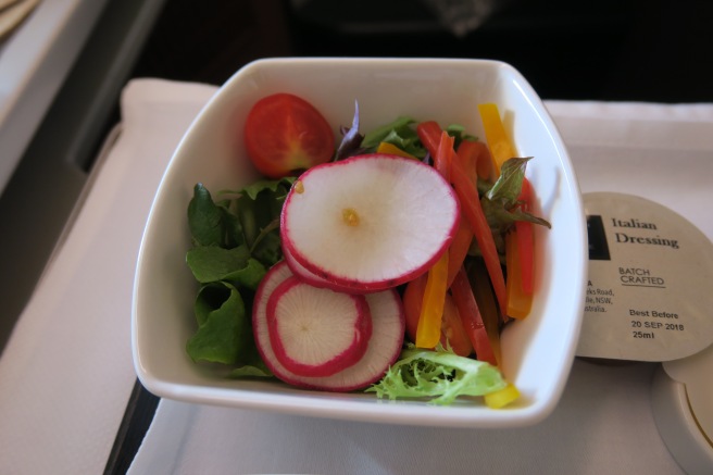 a bowl of salad on a tray