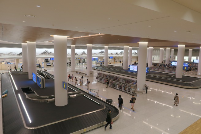 a large airport with several people walking around