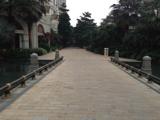 a walkway with trees and buildings