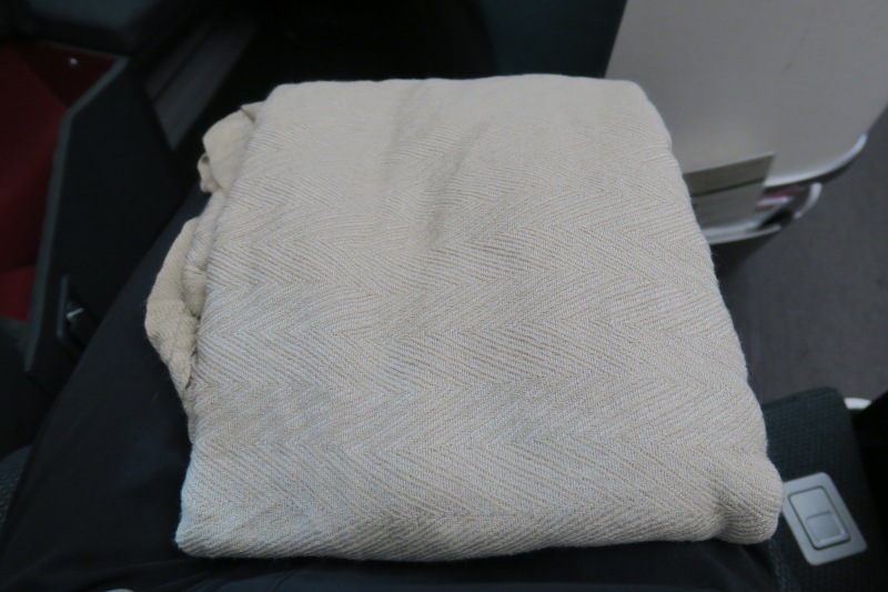 a folded blanket on a black surface