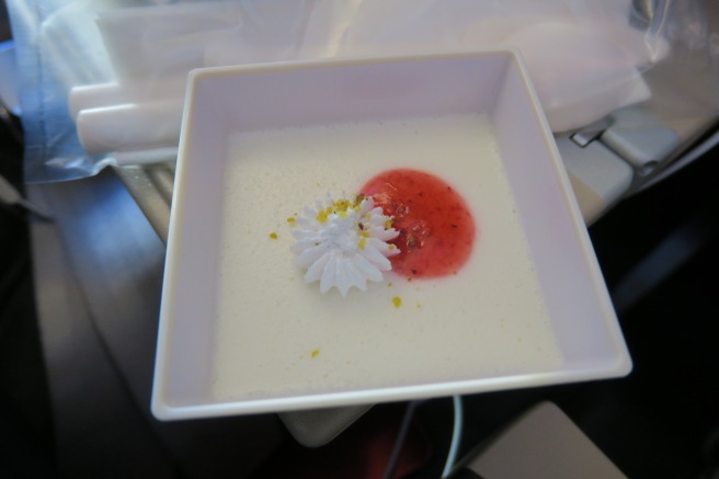 a white bowl with a flower in it