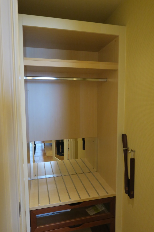 a closet with shelves and a rolling pin
