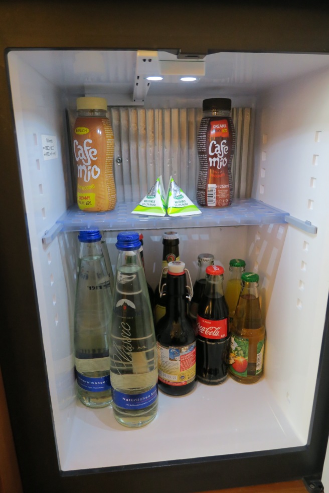 a refrigerator with bottles of beverage
