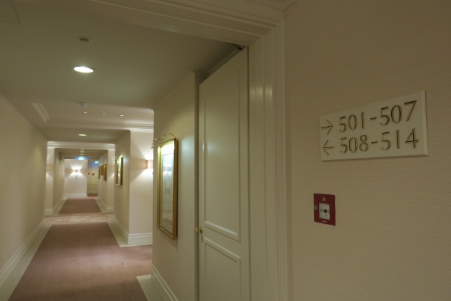 a hallway with a door and signs