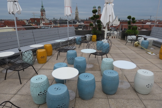 a group of tables and chairs on a rooftop