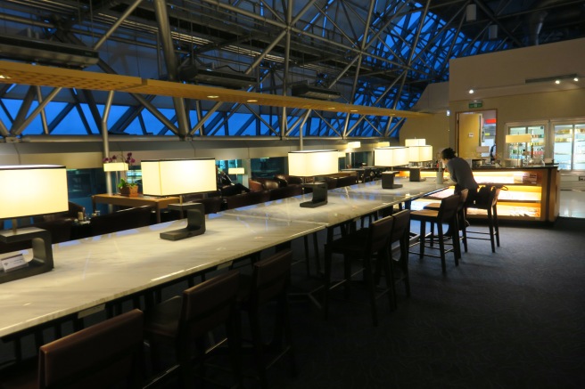 a long table with lamps in a room