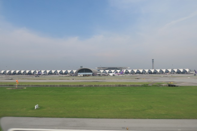 a large airport with a large building and grass