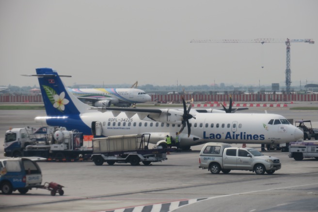 a group of airplanes at an airport