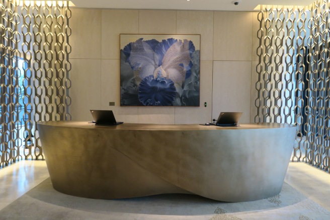 a reception desk with laptops on it
