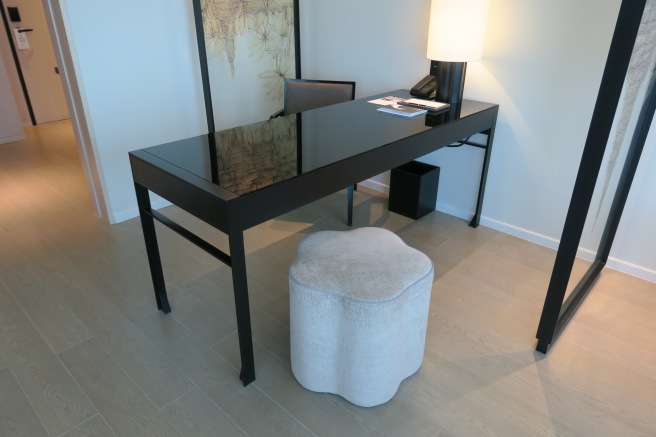 a black desk with a white stool