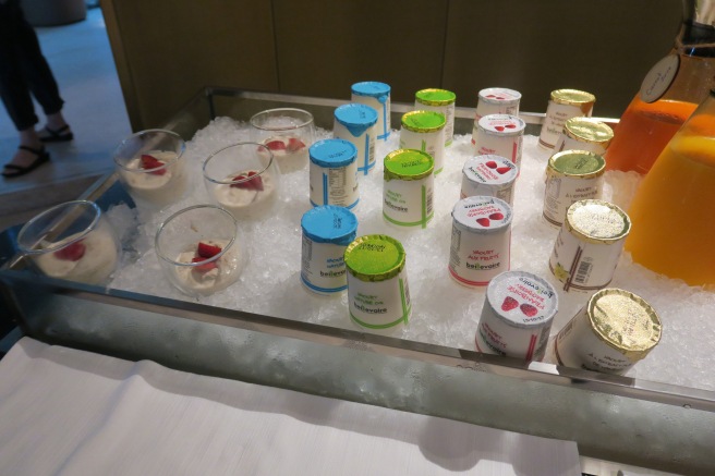 a tray of yogurts and strawberries
