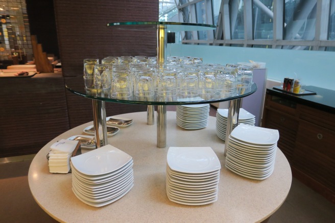 a stack of plates and glasses on a table