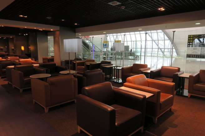 a lounge area with chairs and tables