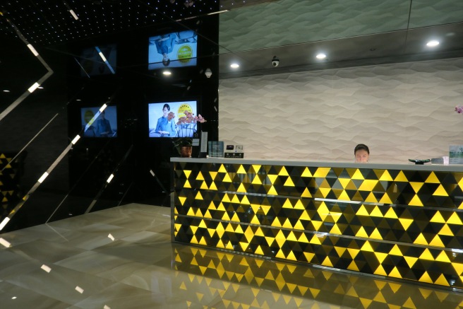 a reception desk with a couple of people behind it