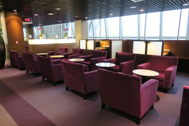 a room with purple chairs and tables