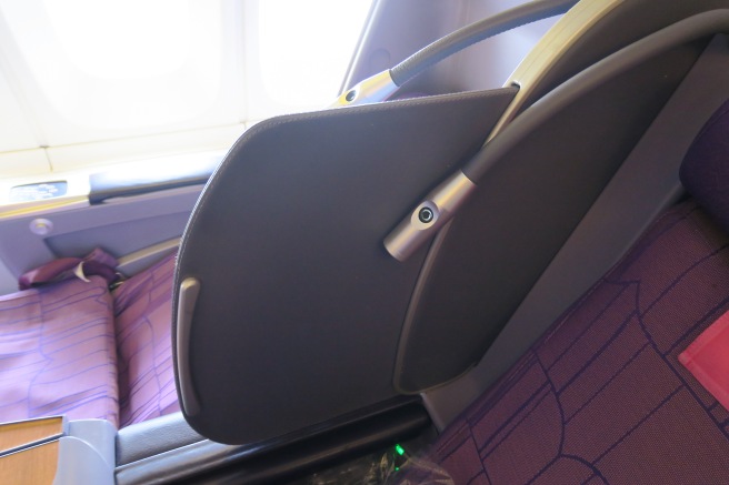 a seat with a metal arm rest
