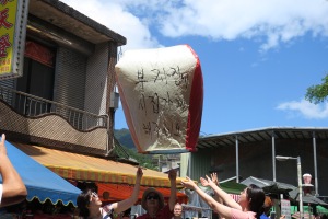 a group of people throwing a paper lantern