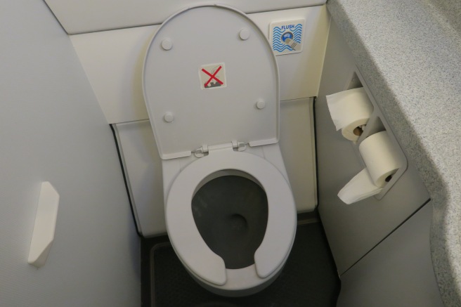 a toilet with a red x on the lid