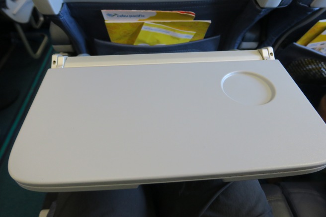 a white rectangular object on a person's lap