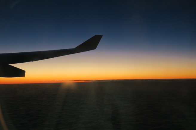 an airplane wing and sunset
