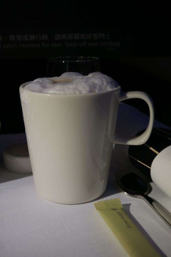 a white mug with foam in it