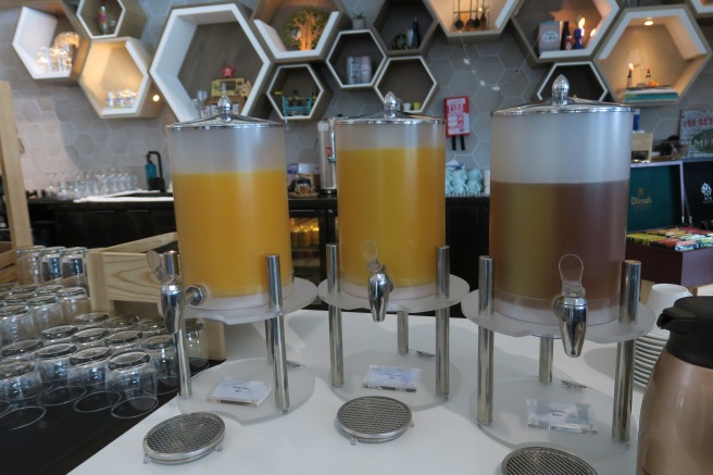 a group of beverage dispensers on a table