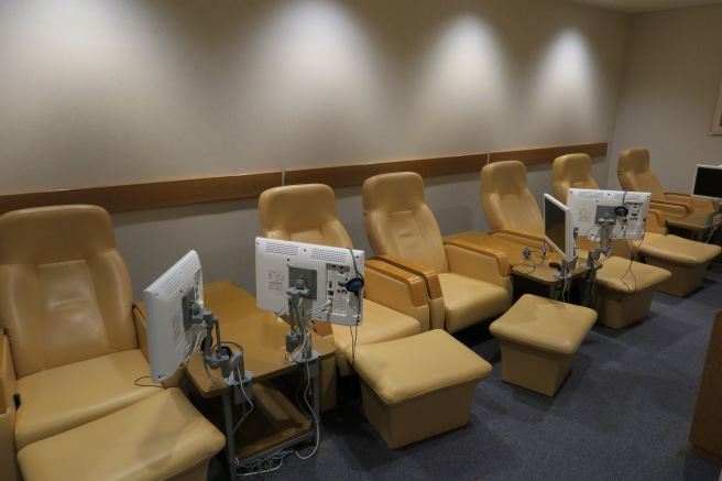 a row of chairs with computers