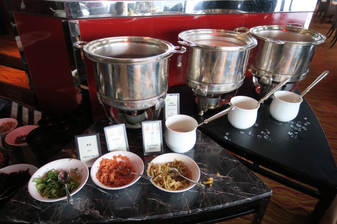 a buffet with many bowls of food