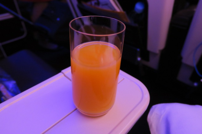 a glass of orange juice on a table