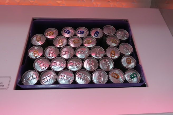 a group of cans in a purple container