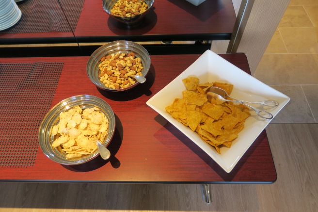 a bowl of chips and nuts on a table