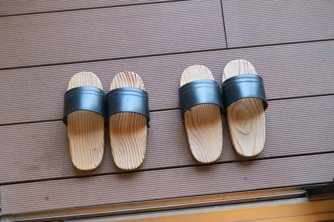 a pair of wooden sandals on a deck