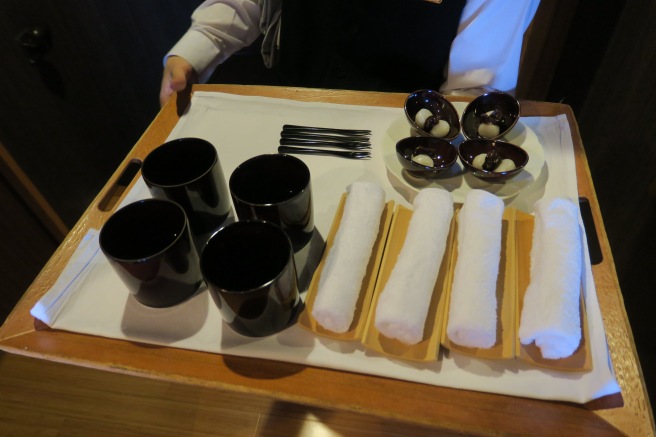 a tray with utensils and cups on it