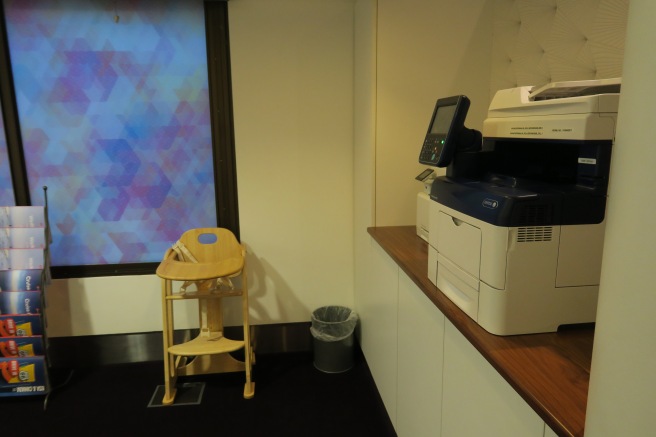 a printer and a chair in a room
