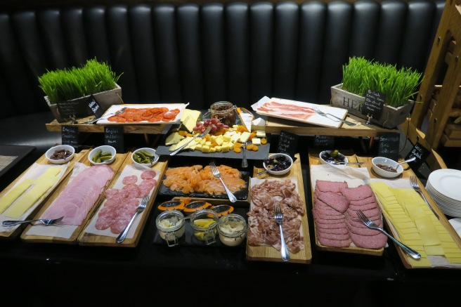 a table with different types of meats and cheeses