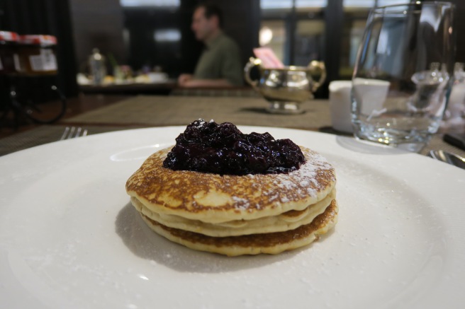 a stack of pancakes with jam on top