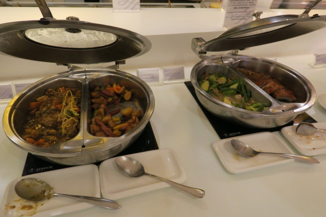 food in a buffet with spoons