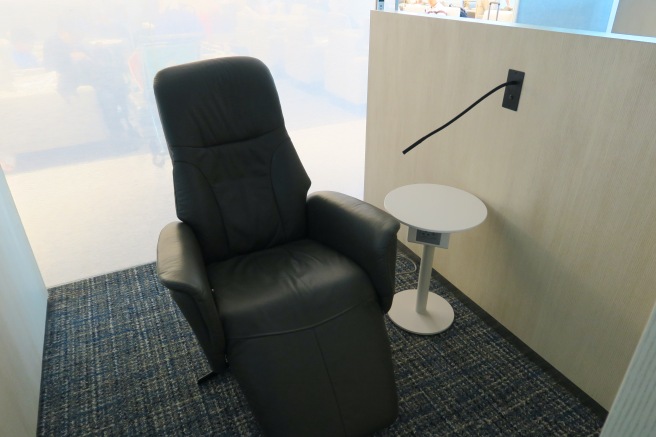 a black leather chair next to a small table